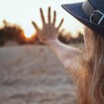 Donna che esamina un integratore di vitamina D con espressione pensierosa.